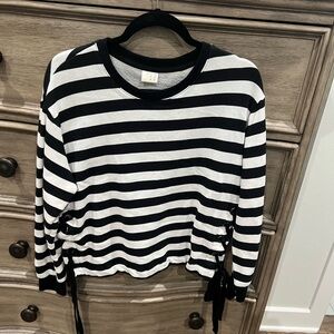 Striped black and white long sleeved top with ties at waist.